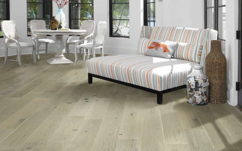 Blended beige and grey tones flooring with a multicoloured pinstripe chair in the background