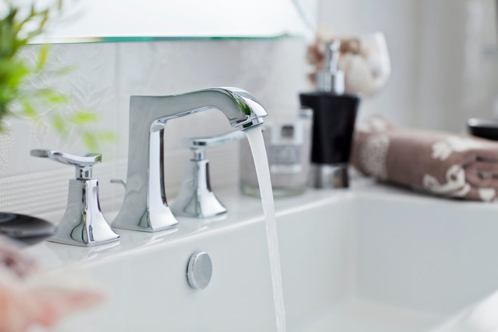 Simple silver faucet with running water