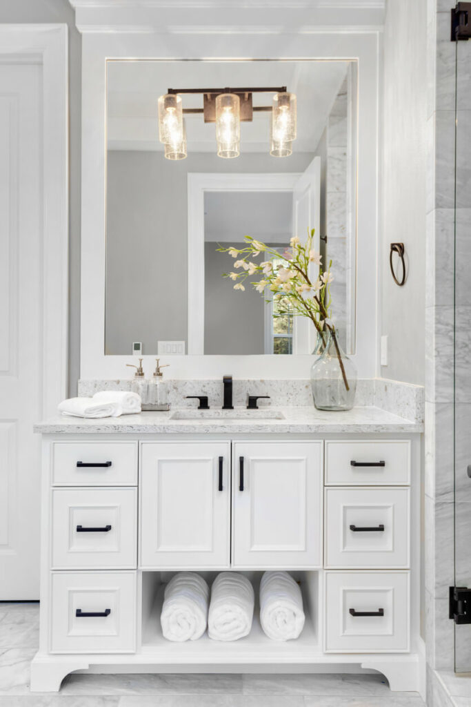 A classic white vanity with drawers and cupboards