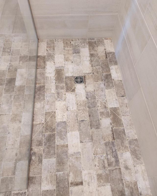 A photo of a shower floor with tile installed.