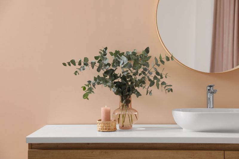 A photo of decorative eucalyptus on a bathroom vanity. 